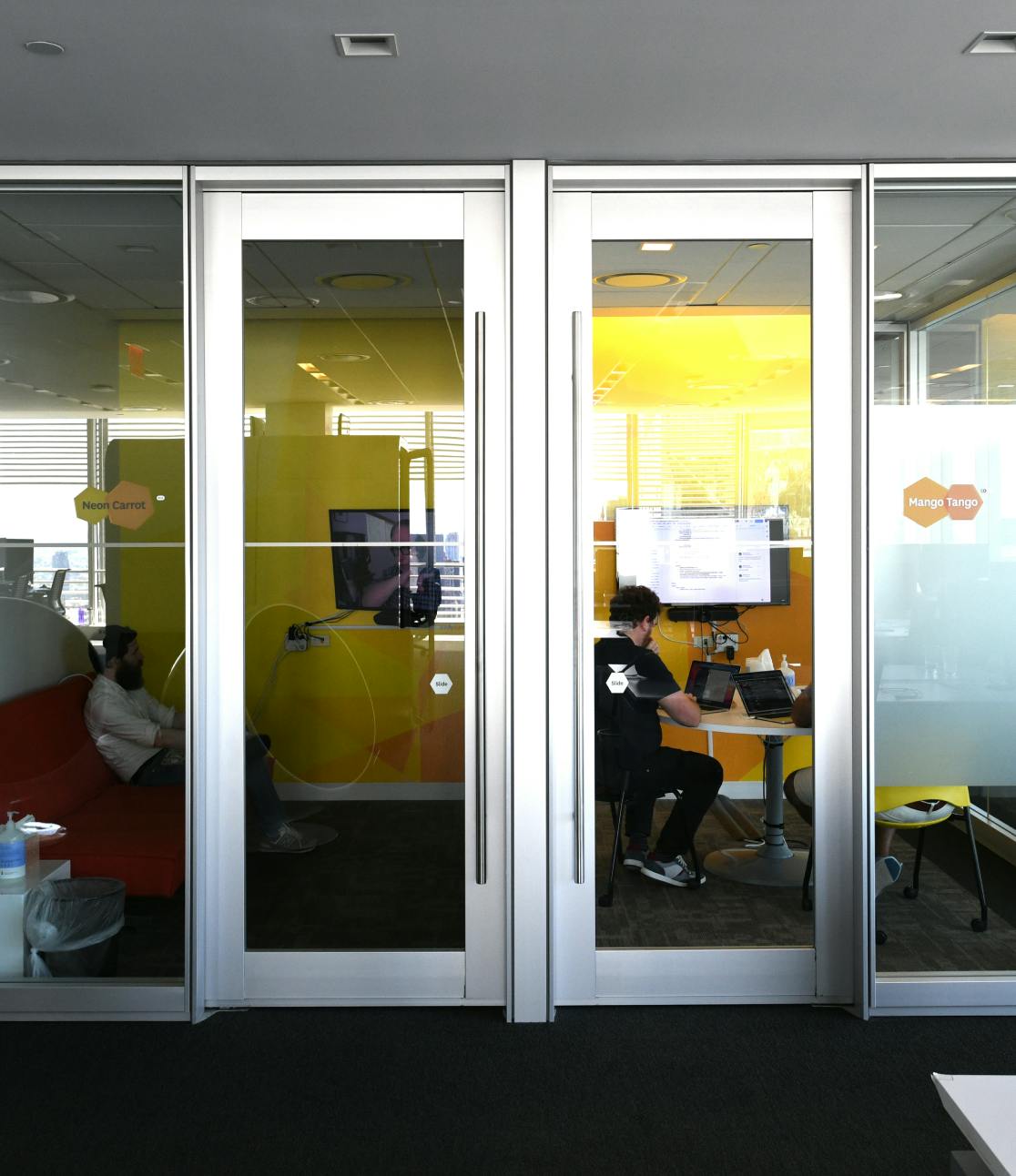 A photograph of the outside wall of two neighboring Datadog conference rooms.