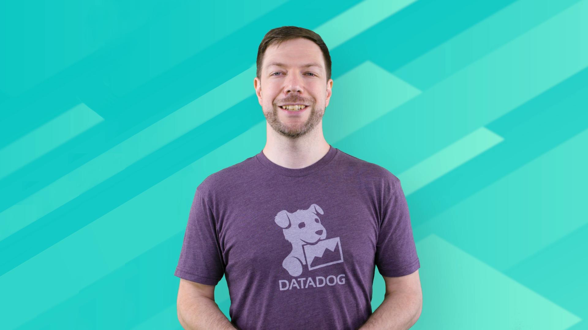 A thumbnail image taken from the Datadog AWS re:Invent 2021 Virtual Welcome Video; the frame includes a 1/2 headshot of a Technical Evangelist wearing a Datadog tee and in front of a digital cyan background.