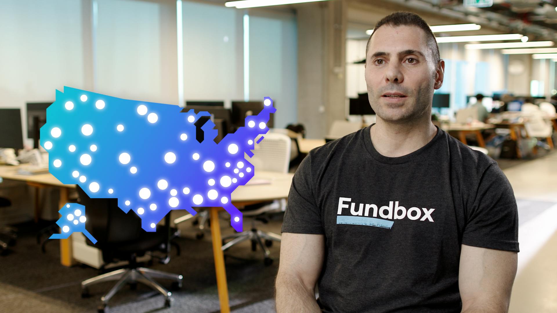 Thumbnail taken from the Fundbox testimonial video; a headshot of a Fundbox employee in a company tee seated in an open office space.